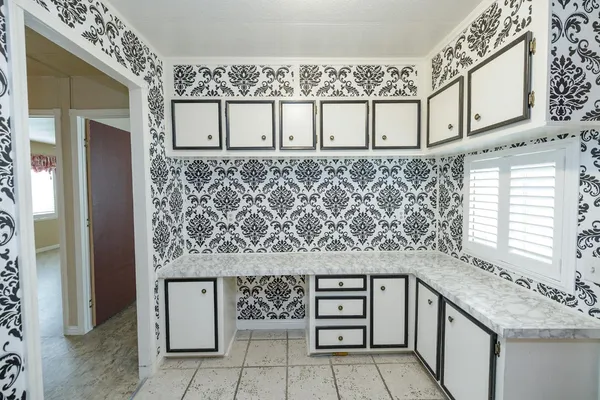 a view of a livingroom with a ceiling fan and window