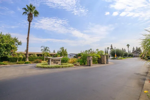 a view of a street with a cars parked in front of it