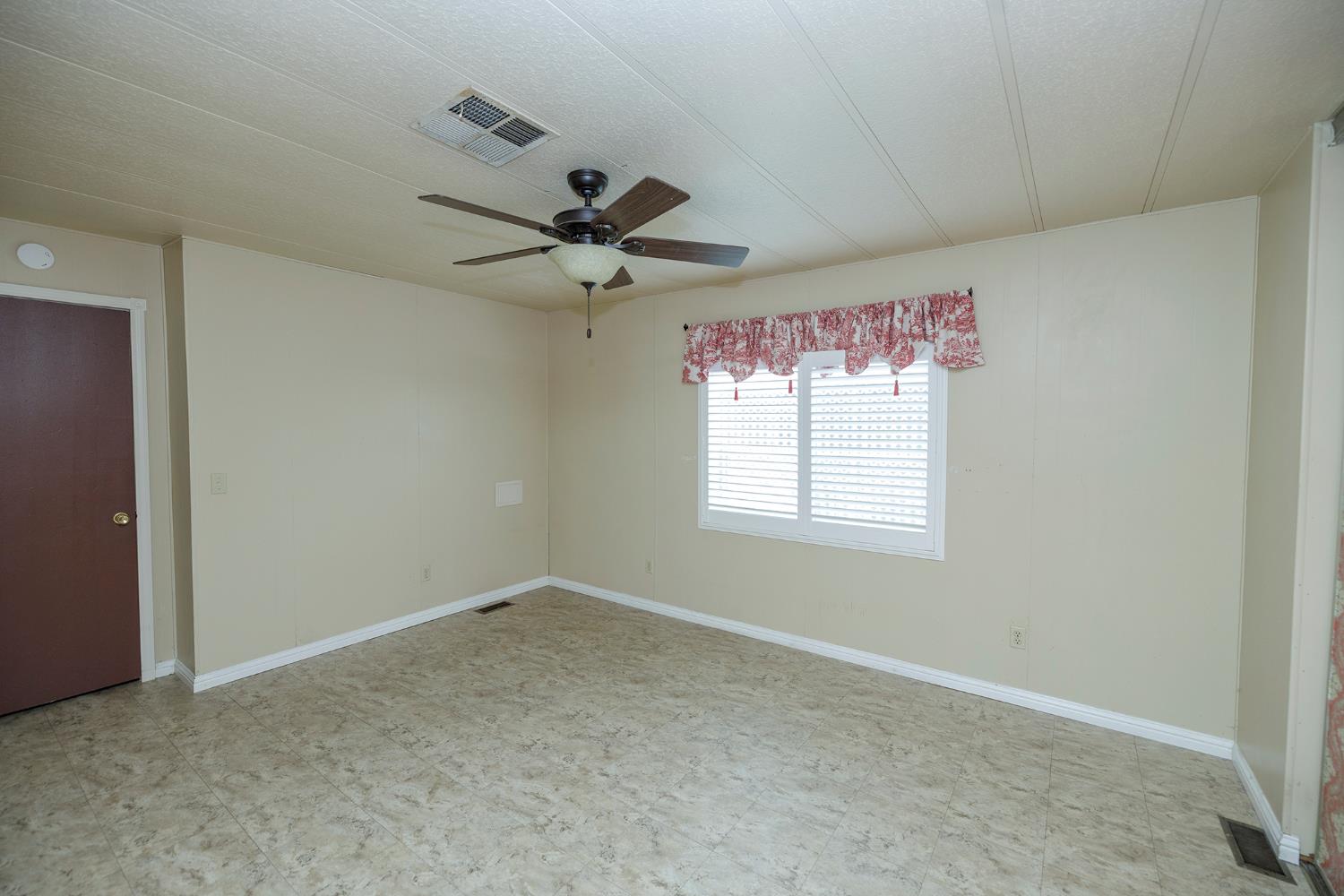 3924 Lahaina Lane Modesto, CA 95355 - Photo 23 of 32 a view of a livingroom with a ceiling fan and window