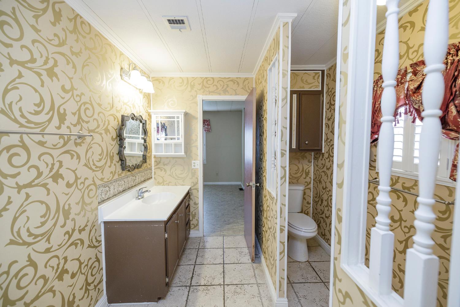 3924 Lahaina Lane Modesto, CA 95355 - Photo 26 of 32 a bathroom with a bathtub sink mirror and toilet