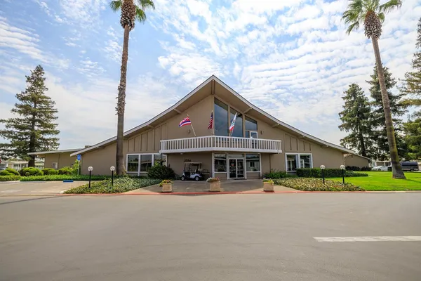 a view of street with cars parked in front of it