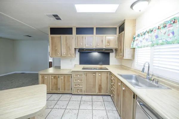 a kitchen with a refrigerator and a sink