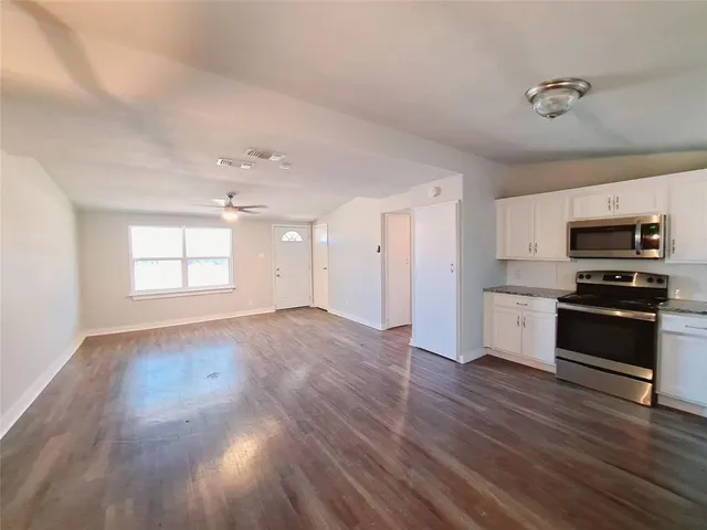 a view of kitchen with sink microwave and stove top oven