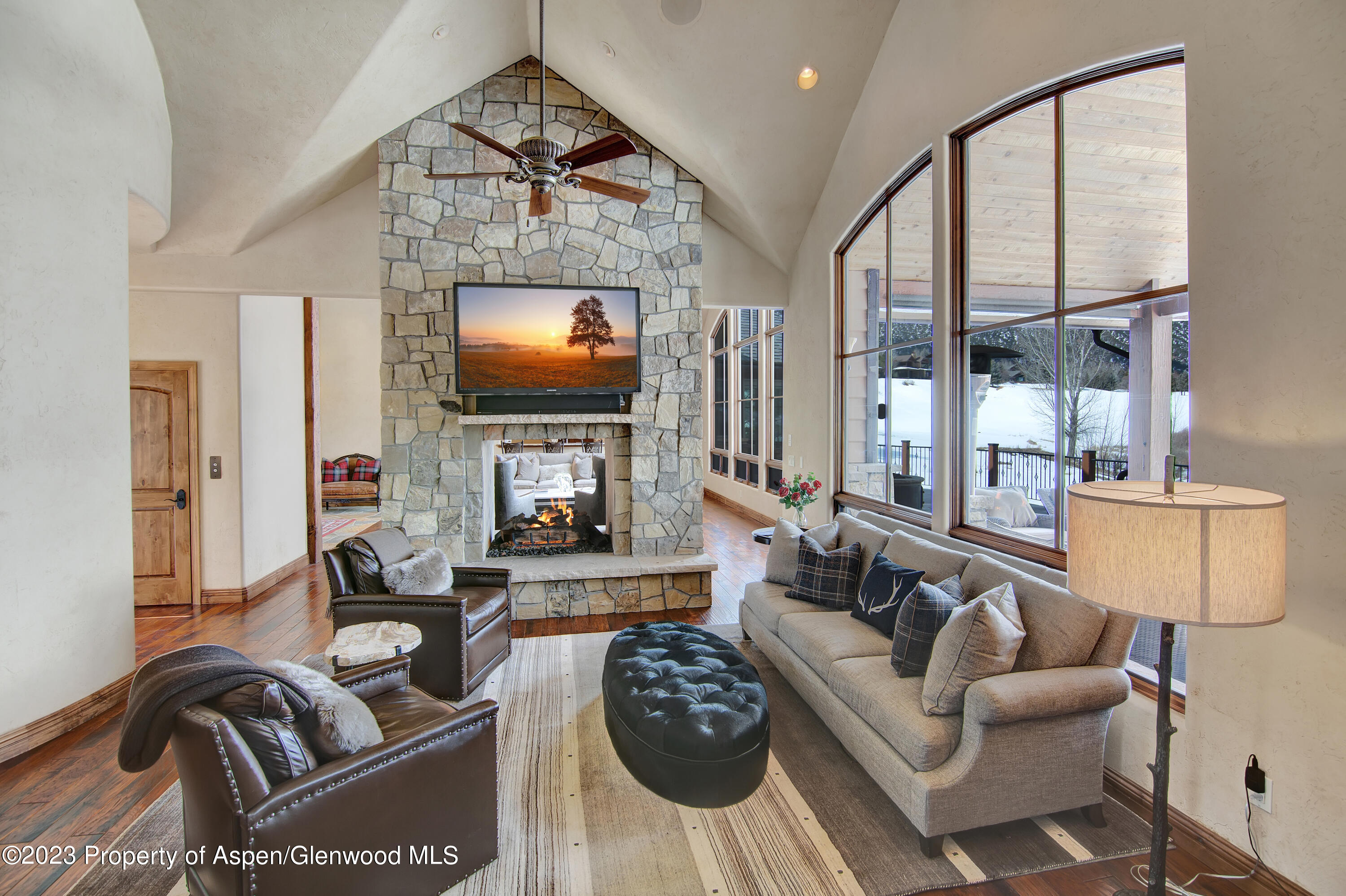160 River Glen Road Carbondale, CO 81623 - Photo 7 of 24 a living room with furniture a flat screen tv and a large window