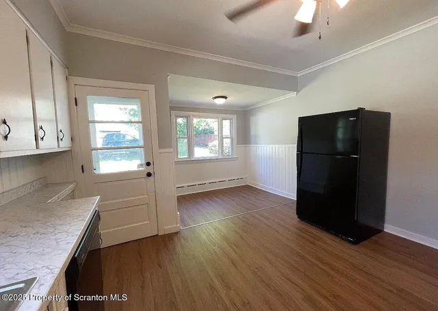 a kitchen with granite countertop a refrigerator and a stove
