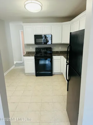a view of a hallway and wooden floor with staircase