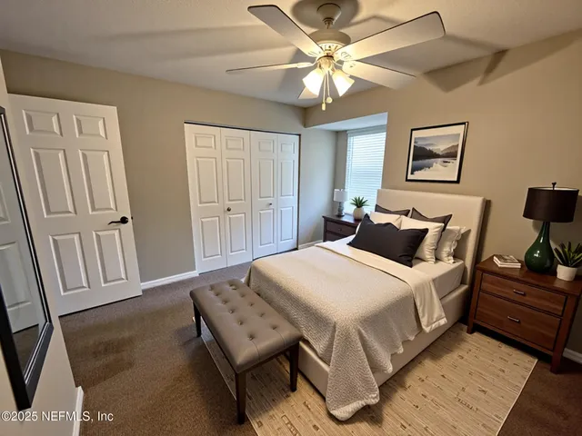 an empty room with windows and fan