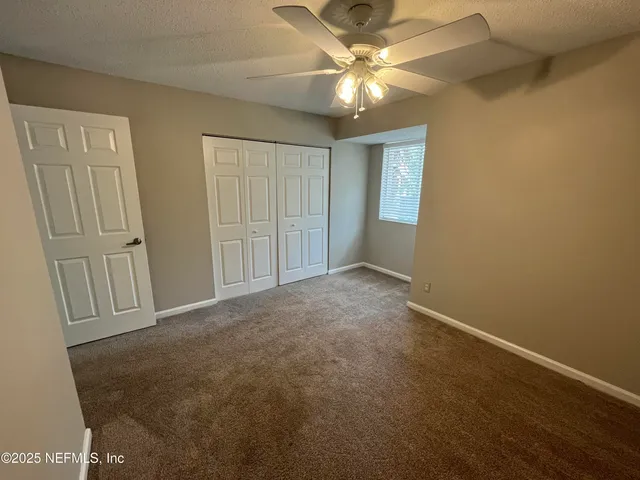 a bedroom with a bed a table and chair