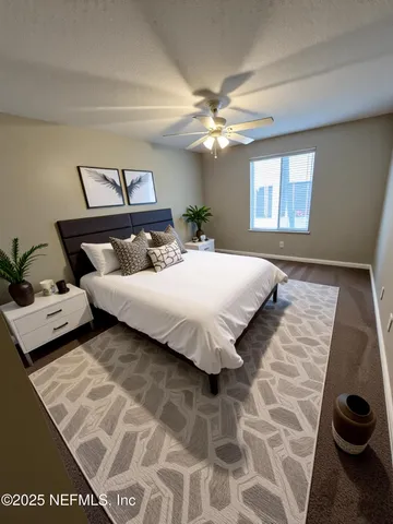 en empty room with windows and ceiling fan