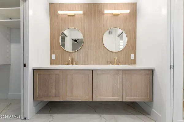 a bathroom with a double vanity sink and a mirror