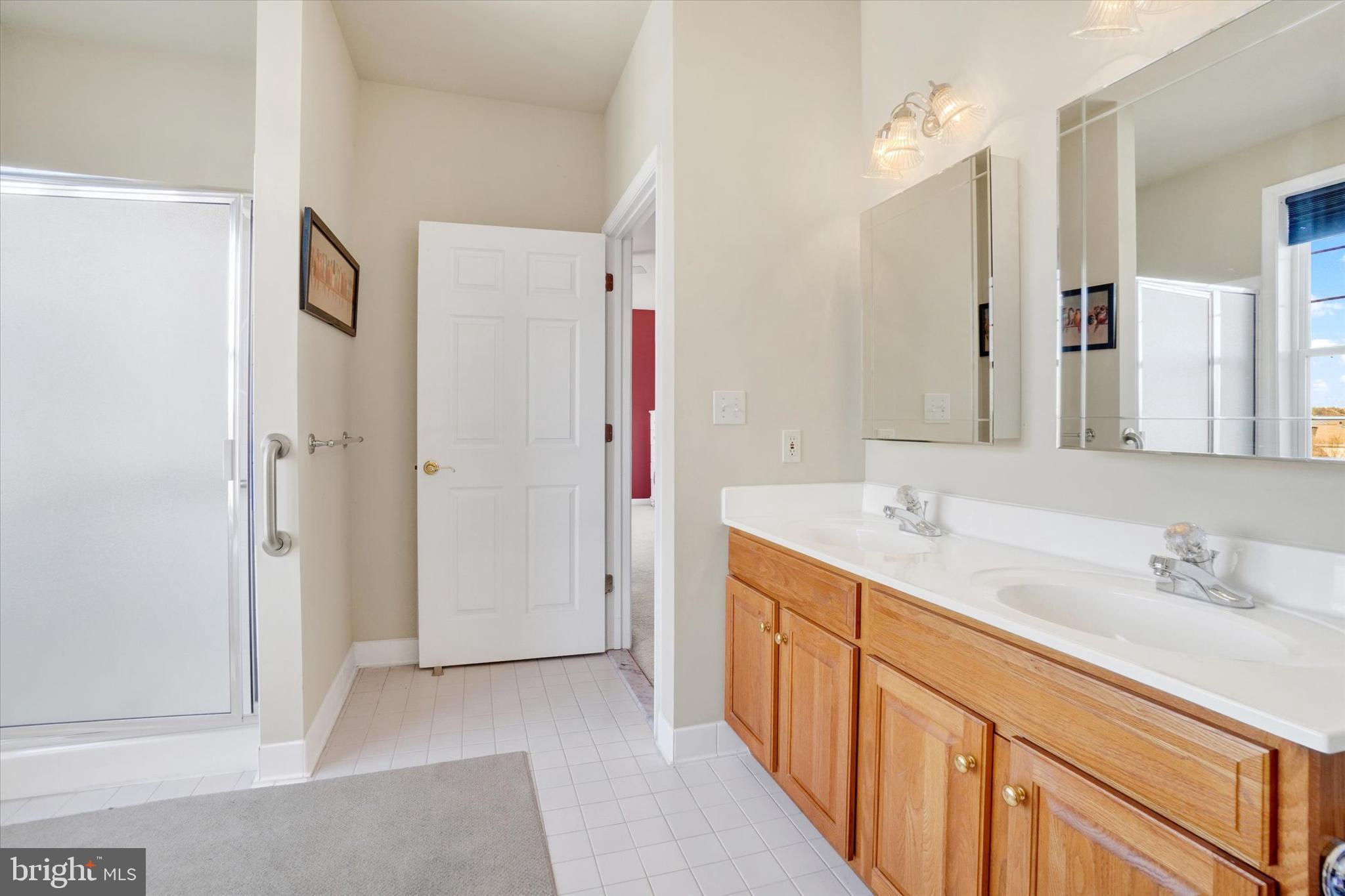 1010 Crest Way, Unit 304 York, PA 17403 - Photo 19 of 24 a bathroom with a double vanity sink and mirror