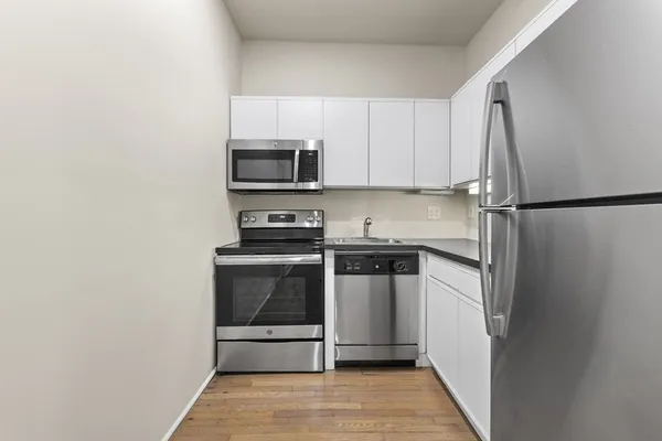 a kitchen with a refrigerator stove and microwave