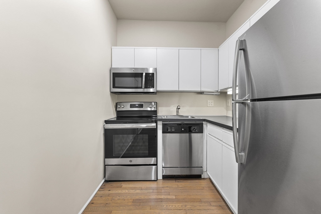 74 Fenway, Unit 45 Boston, MA 02115 - Photo 3 of 12 a kitchen with a refrigerator stove and microwave