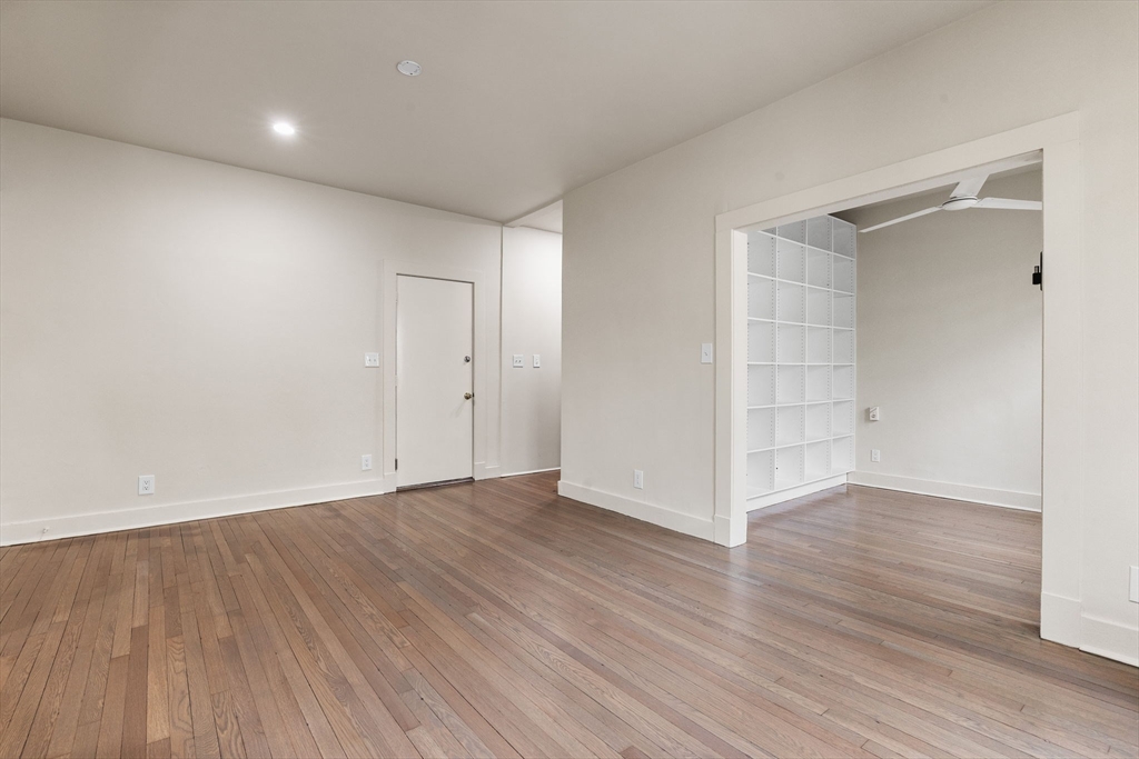 74 Fenway, Unit 45 Boston, MA 02115 - Photo 6 of 12 a view of an empty room with wooden floor and closet