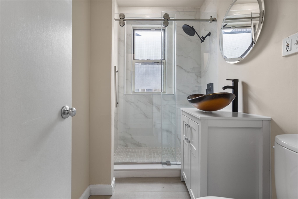 74 Fenway, Unit 45 Boston, MA 02115 - Photo 10 of 12 a bathroom with a sink a toilet and shower