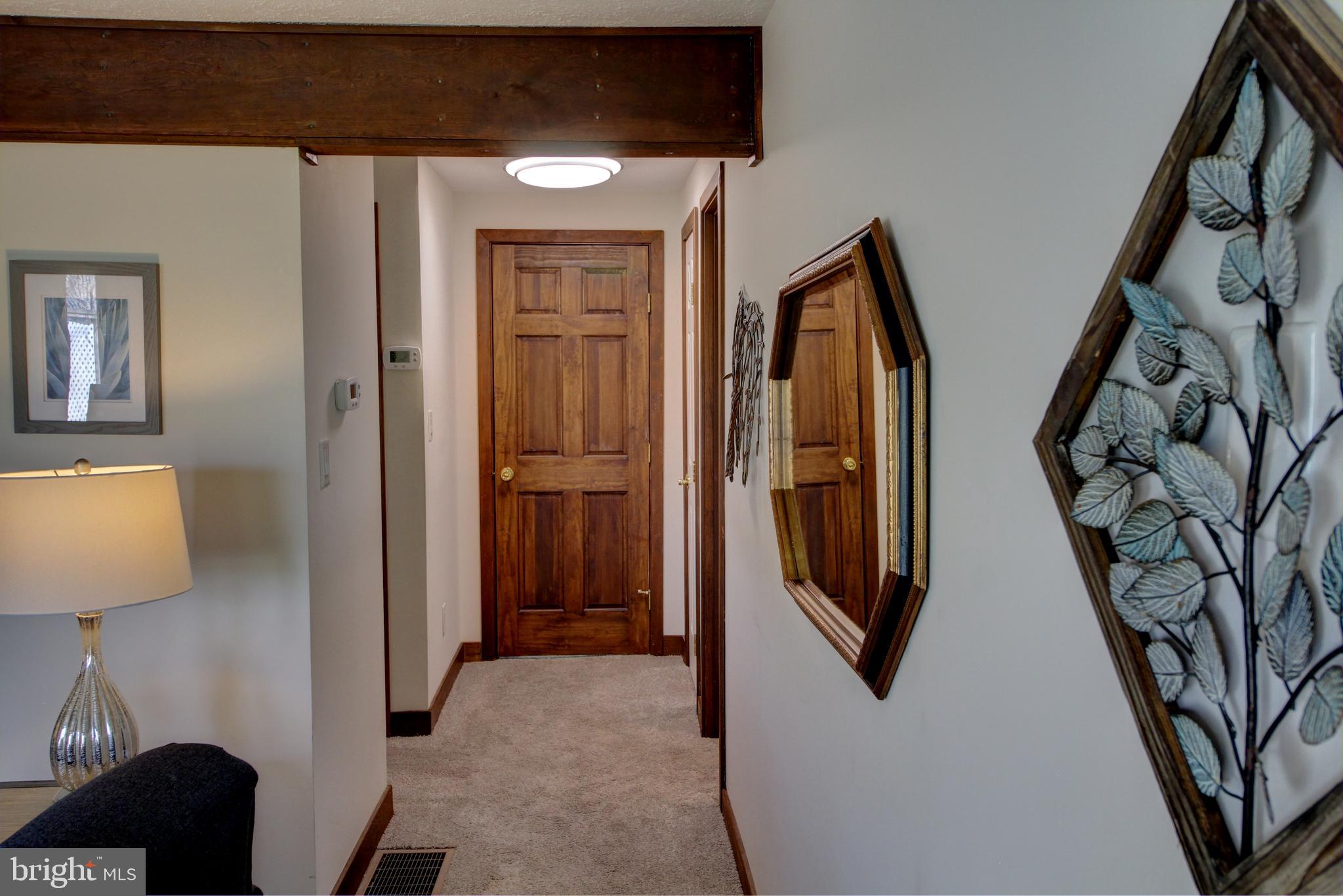 361 The Hill Road, Unit M4 Basye, VA 22810 - Photo 17 of 19 a view of a hallway with wooden floor and stairs