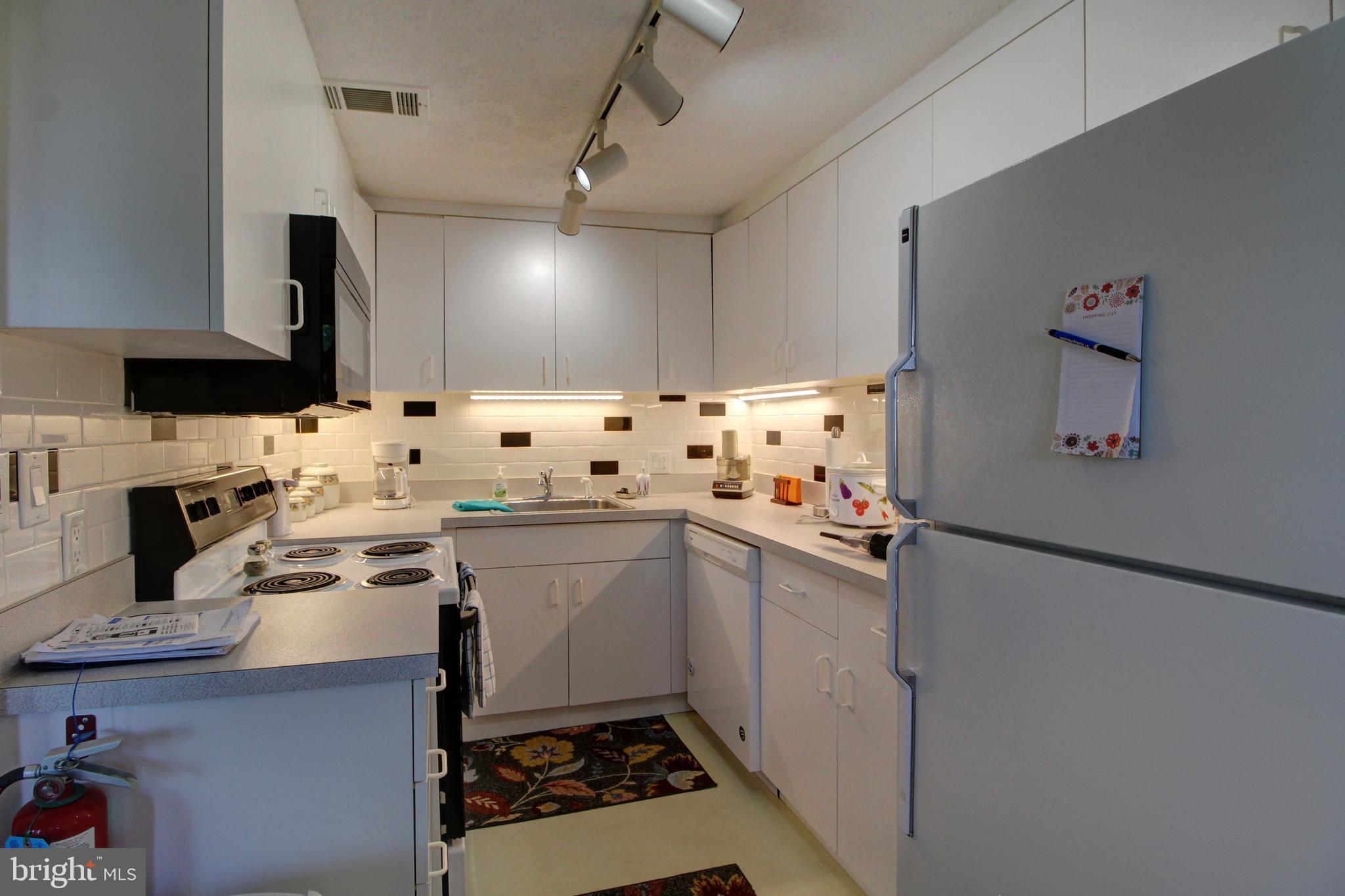 361 The Hill Road, Unit M4 Basye, VA 22810 - Photo 6 of 19 a kitchen with a sink appliances and cabinets