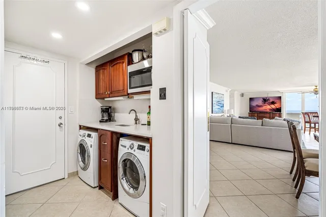 a kitchen with stainless steel appliances kitchen island a large window and refrigerator