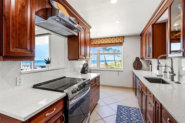 a kitchen with stainless steel appliances granite countertop a refrigerator and a sink
