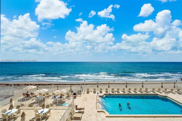 a view of a chairs and table in the balcony