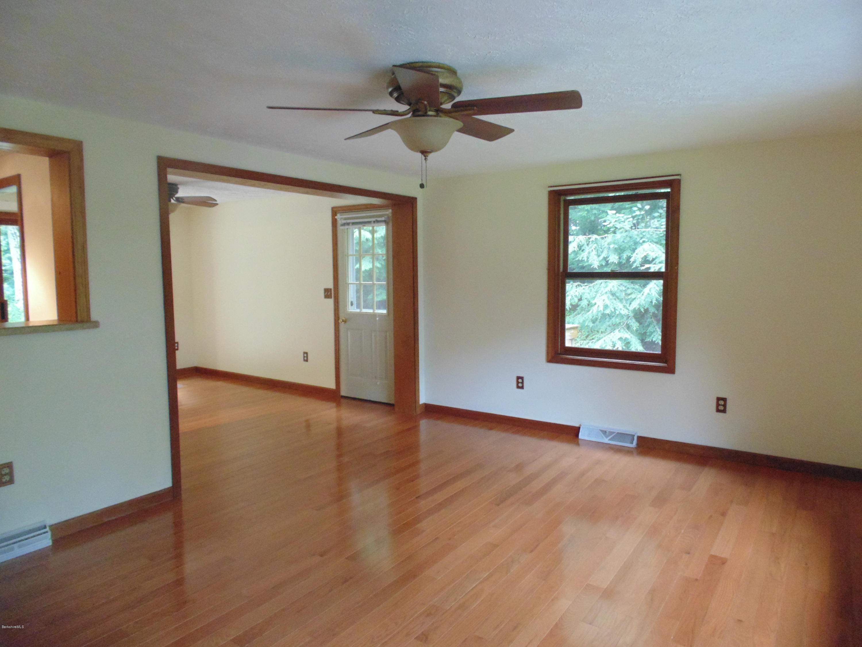 1862 North Main Road Otis, MA 01253 - Photo 3 of 19 a view of an empty room with wooden floor and a window