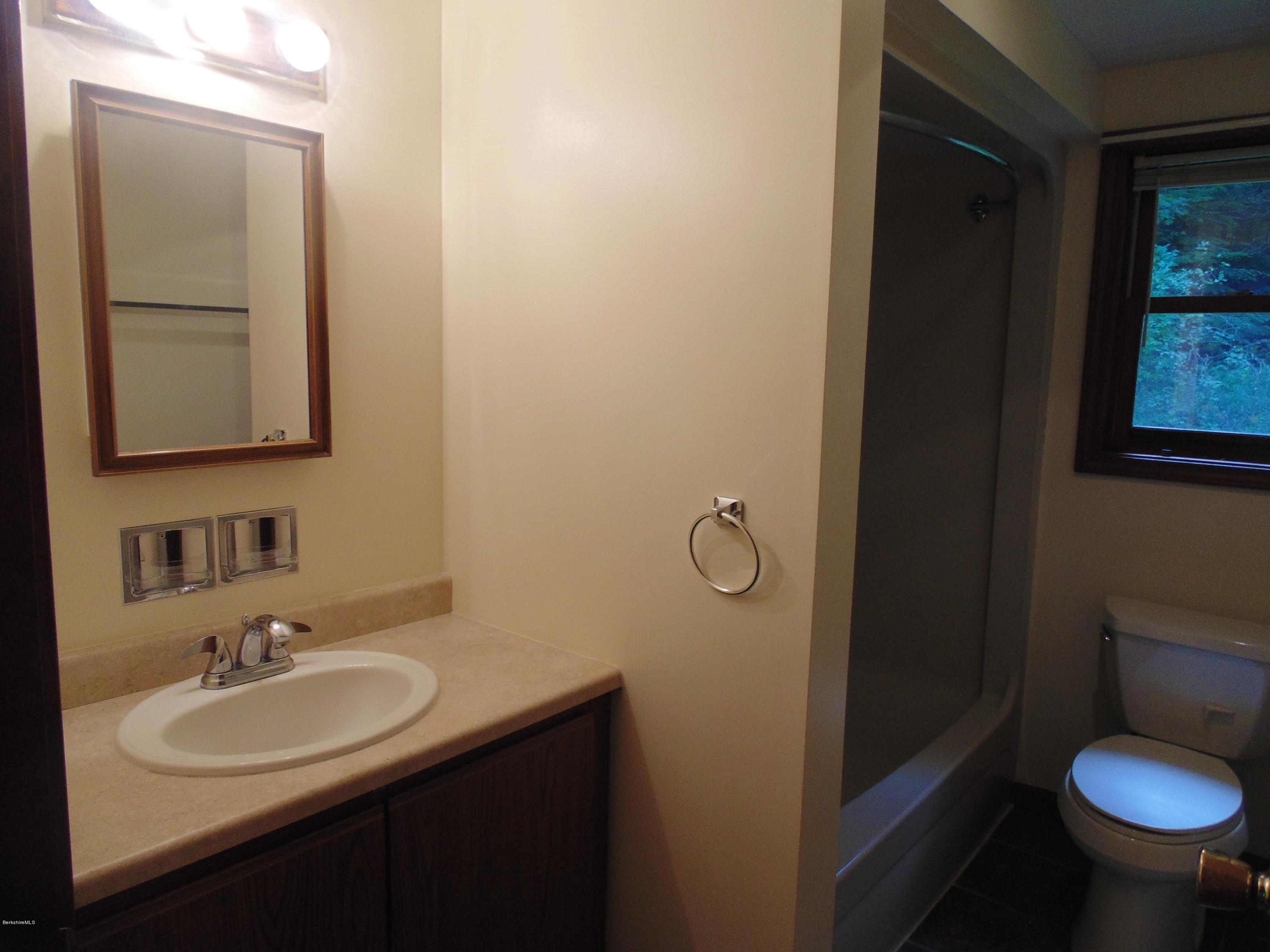 1862 North Main Road Otis, MA 01253 - Photo 8 of 19 a bathroom with a sink toilet and mirror