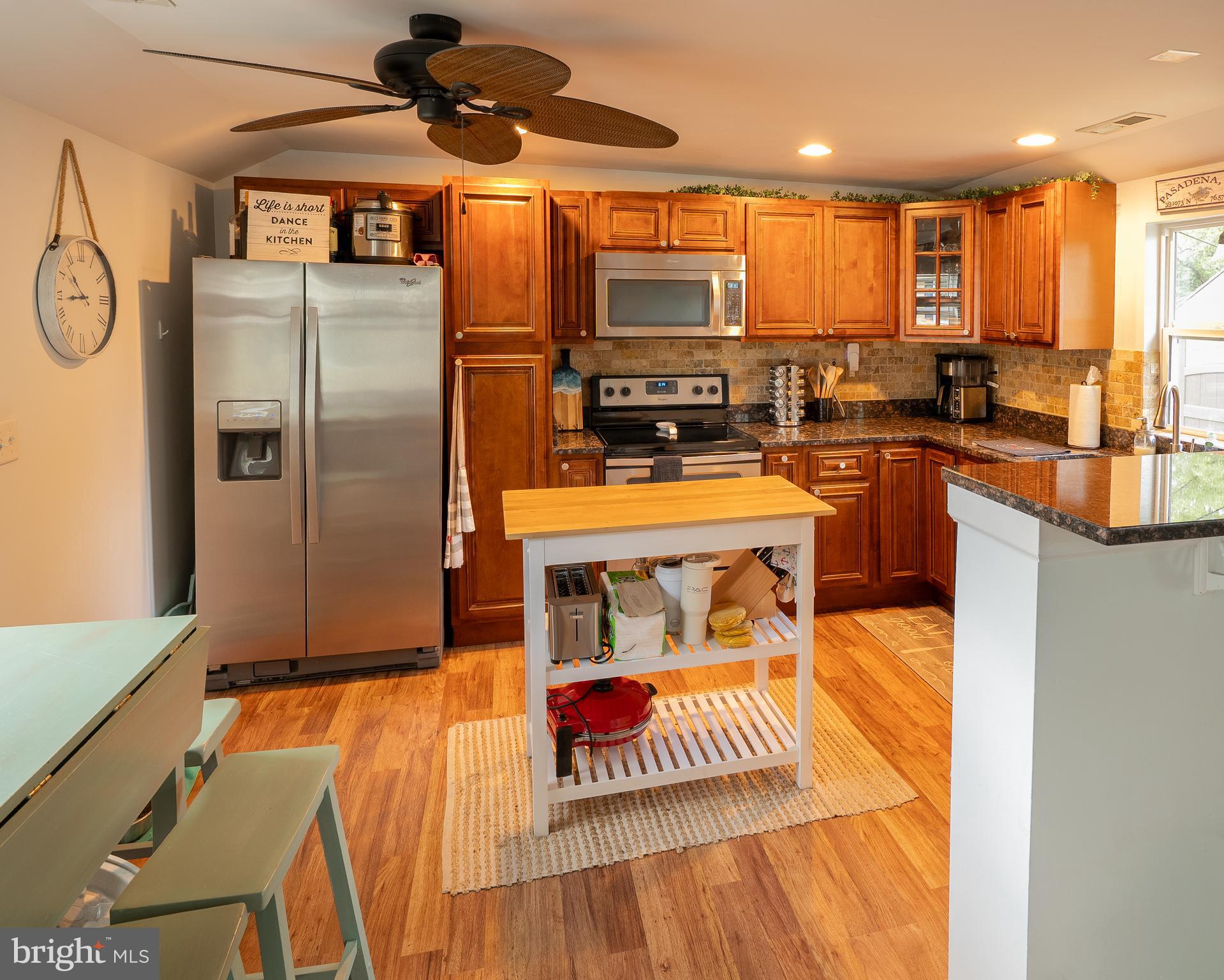 1816 Cremen Road Pasadena, MD 21122 - Photo 10 of 46 a kitchen with stainless steel appliances granite countertop a refrigerator a stove top oven a sink and dishwasher