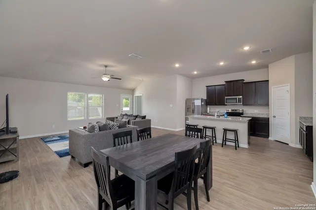 a view of a dining room with furniture and wooden floor