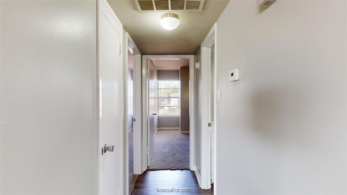 3800 East 29th Street, Unit 11 Bryan, TX 77802 - Photo 6 of 19 a view of a hallway with wooden floor and closet