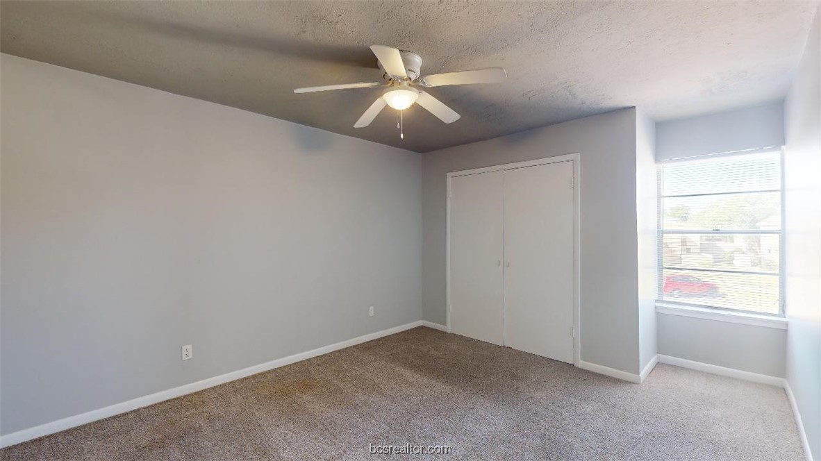 3800 East 29th Street, Unit 11 Bryan, TX 77802 - Photo 8 of 19 an empty room with window and ceiling fan
