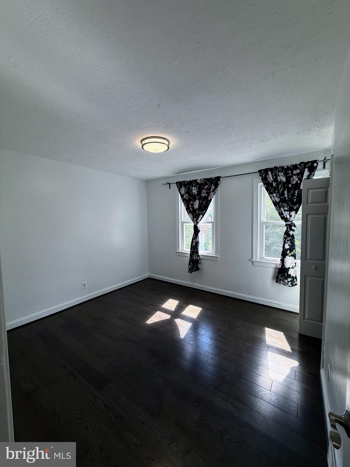 1714 E Street Northeast Washington, DC 20002 - Photo 12 of 30 a view of an empty room with wooden floor and a window