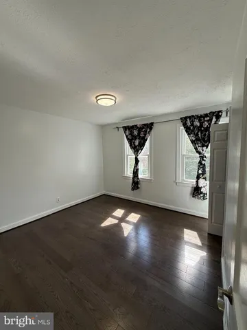 a view of room with window and wooden floor