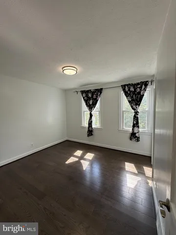 a view of room with wooden floor