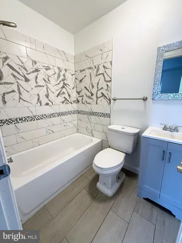 a bathroom with a toilet a sink and bathtub