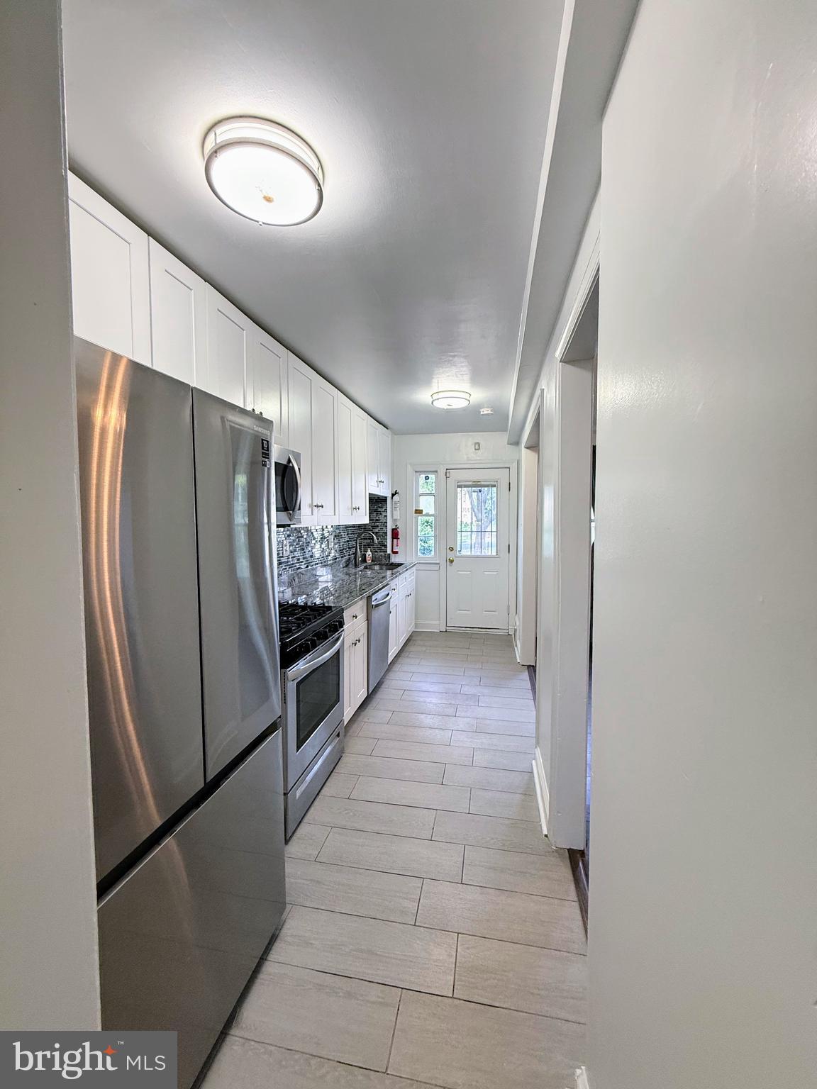1714 E Street Northeast Washington, DC 20002 - Photo 4 of 30 a kitchen with stainless steel appliances a refrigerator and a stove
