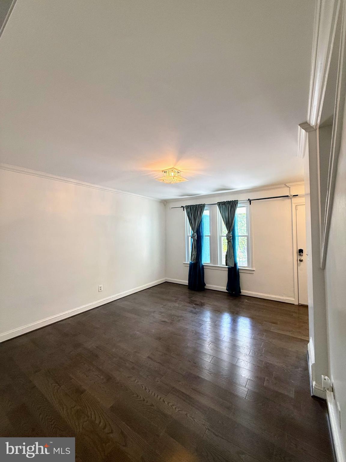 1714 E Street Northeast Washington, DC 20002 - Photo 9 of 30 an empty room with wooden floor and windows