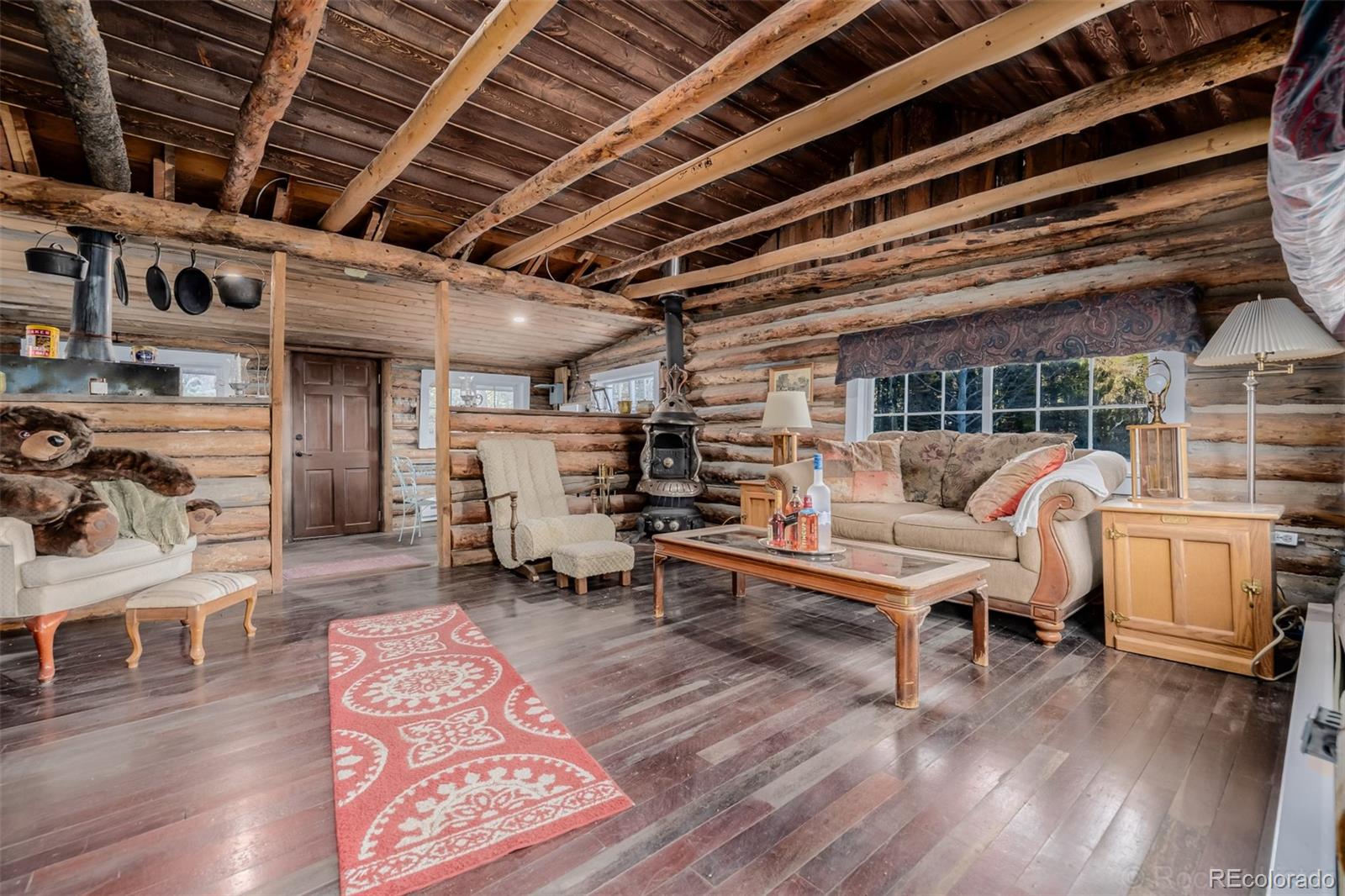 9719 Beaver Pond Conifer, CO 80433 - Photo 11 of 50 a living room with furniture and a wooden floor