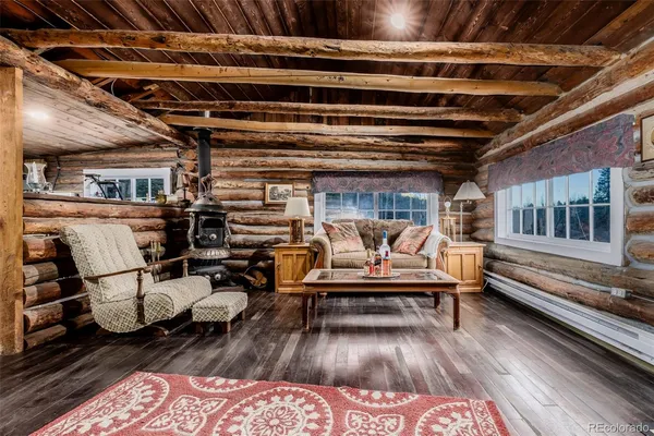 a view of a room with a large window and wooden floor