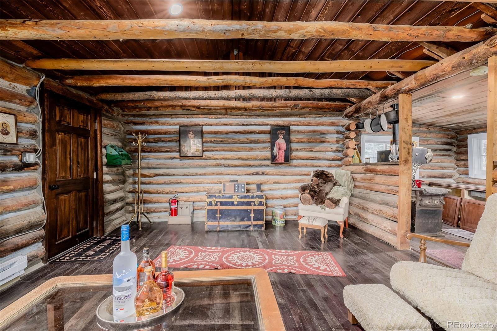 9719 Beaver Pond Conifer, CO 80433 - Photo 15 of 50 a room with furniture and a wooden floor