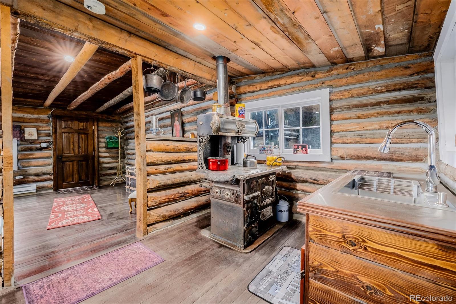 9719 Beaver Pond Conifer, CO 80433 - Photo 17 of 50 a view of kitchen with cabinets and wooden floor
