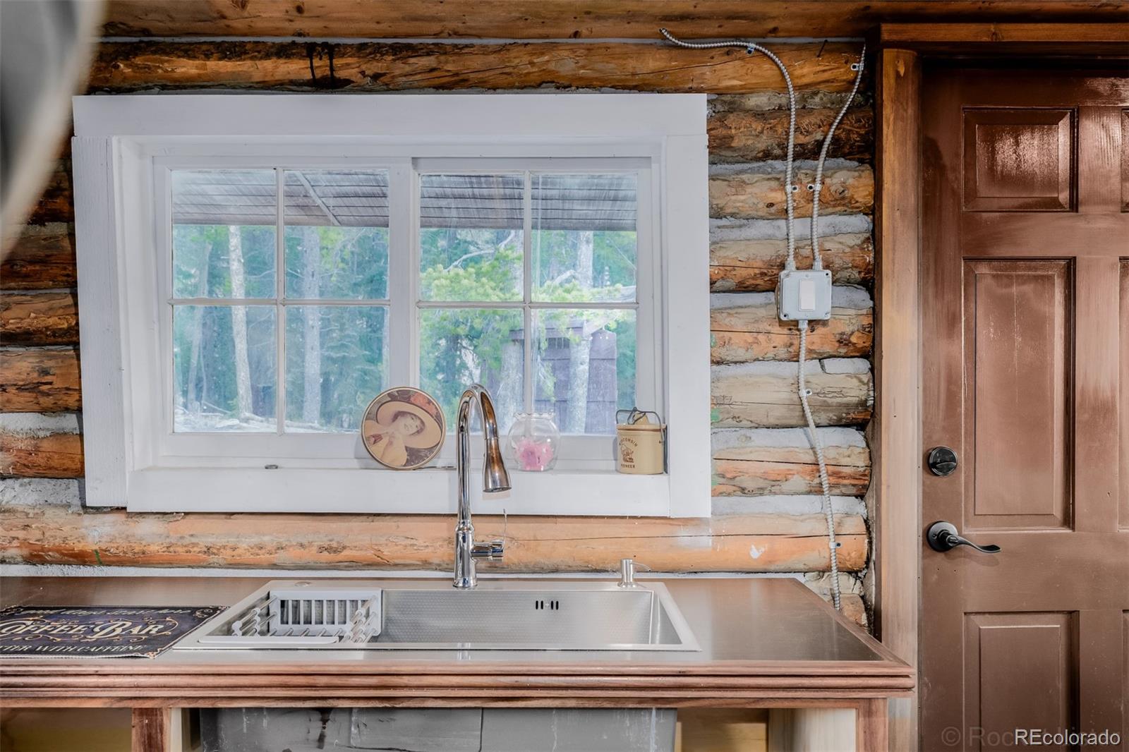 9719 Beaver Pond Conifer, CO 80433 - Photo 19 of 50 a kitchen with a sink and a window
