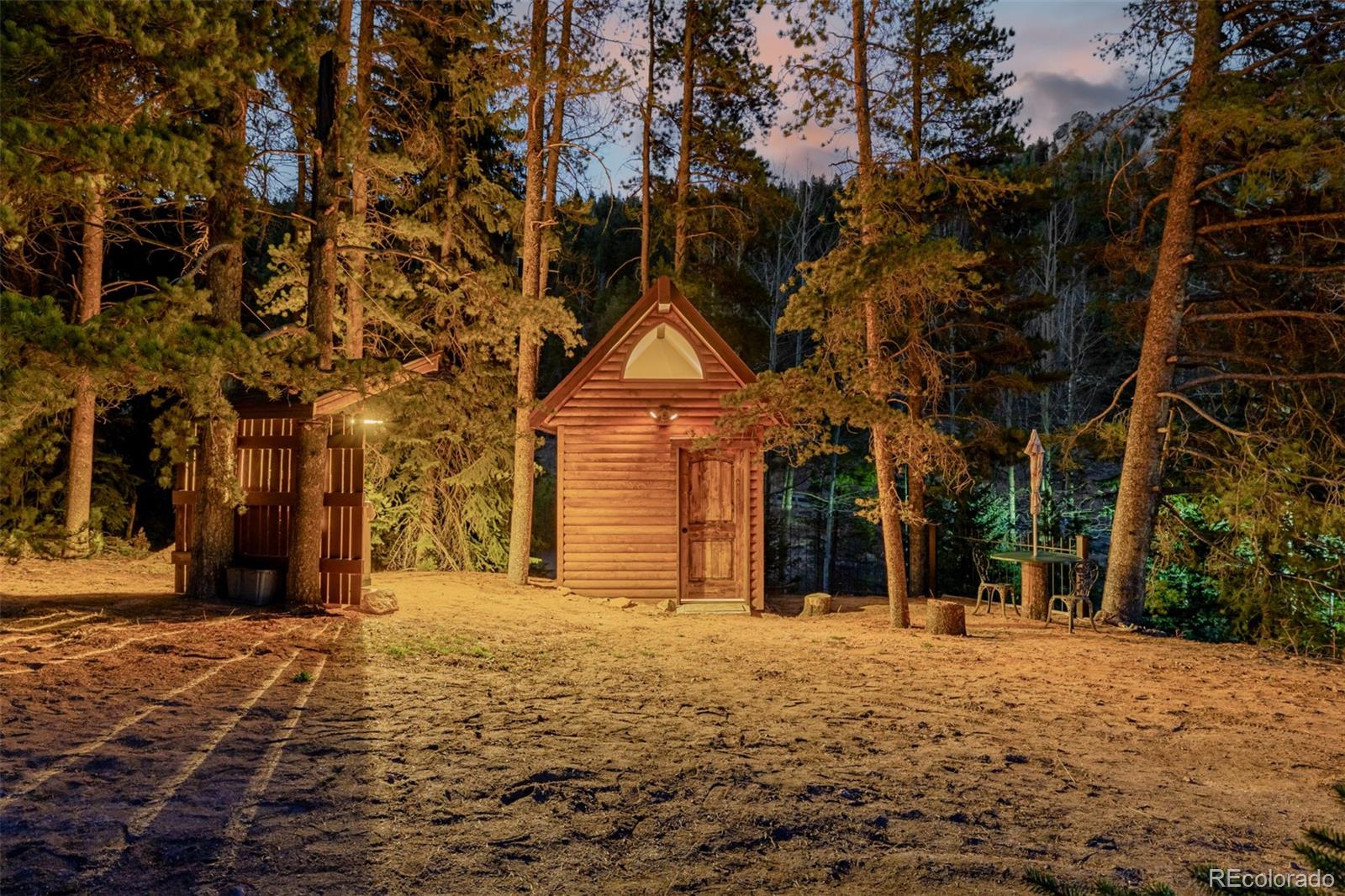 9719 Beaver Pond Conifer, CO 80433 - Photo 30 of 50 a front view of a building with a yard