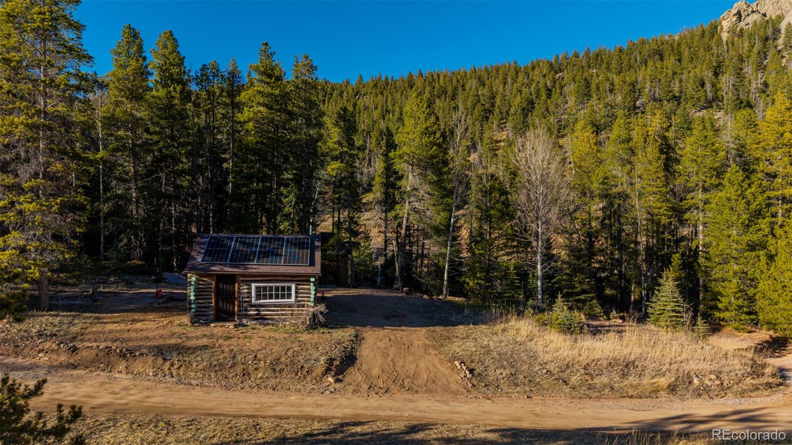 9719 Beaver Pond Conifer, CO 80433 - Photo 40 of 50 a view of a backyard with wooden fence