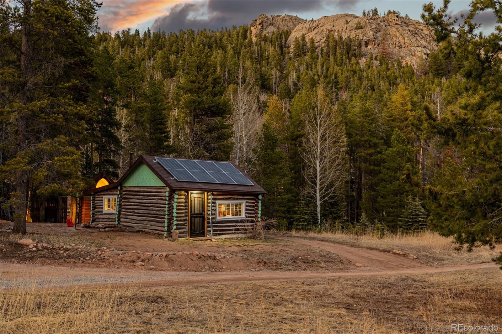 9719 Beaver Pond Conifer, CO 80433 - Photo 4 of 50 a view of a house with a yard and large tree