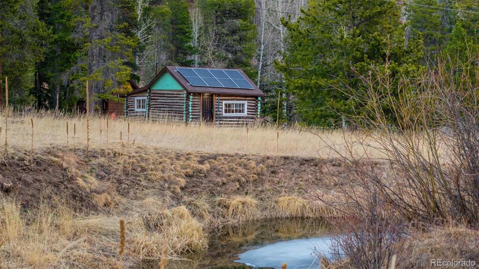 9719 Beaver Pond Conifer, CO 80433 - Photo 43 of 50 a view of a house with a yard