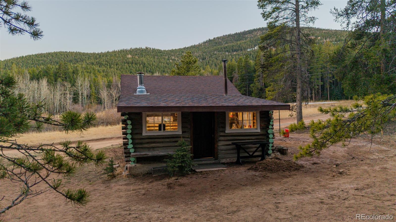 9719 Beaver Pond Conifer, CO 80433 - Photo 46 of 50 a front view of a house with a yard