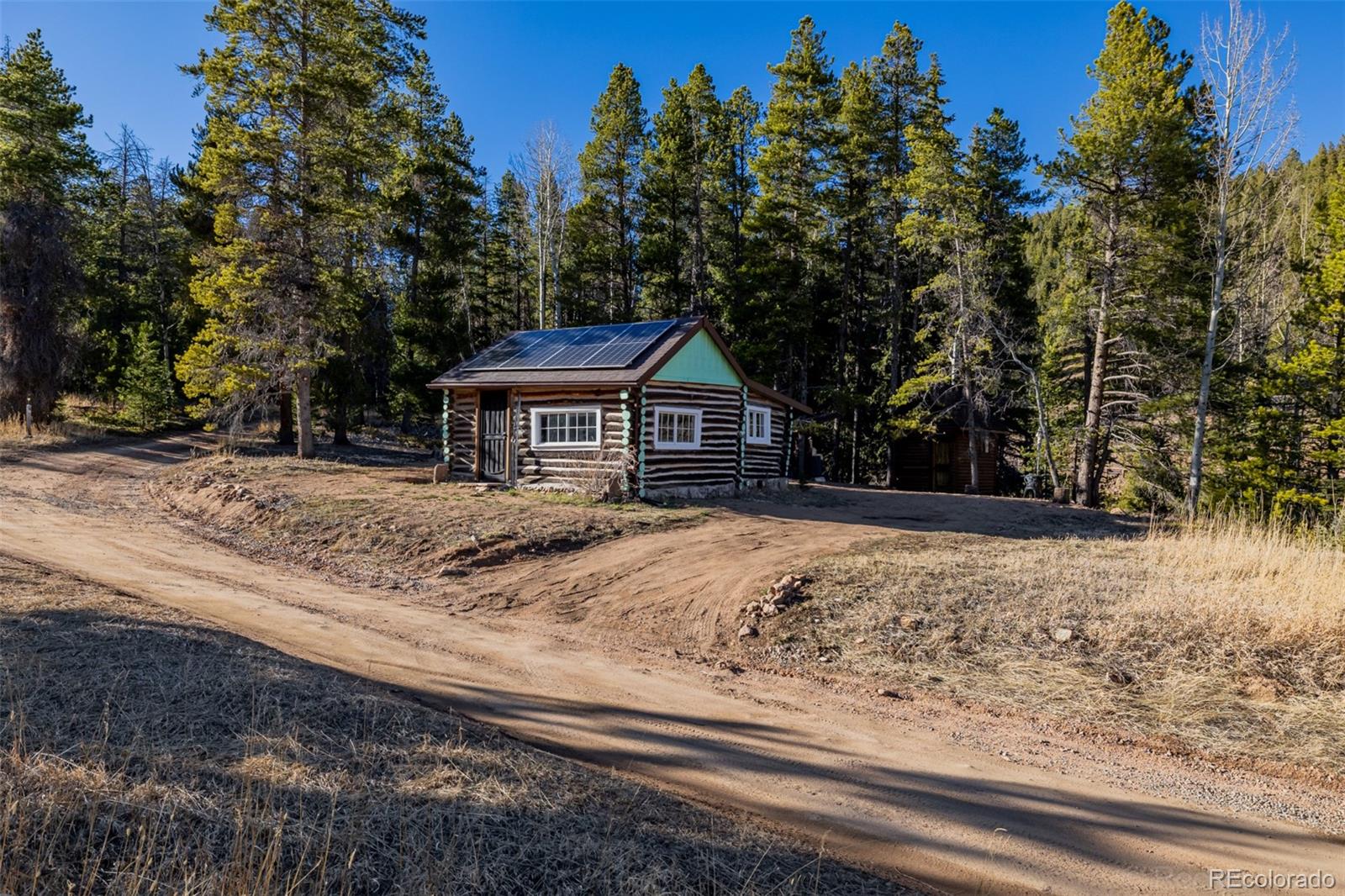 9719 Beaver Pond Conifer, CO 80433 - Photo 6 of 50 a house with trees in the background
