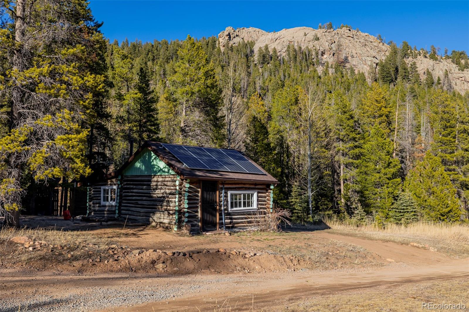 9719 Beaver Pond Conifer, CO 80433 - Photo 8 of 50 a front view of a house with a yard