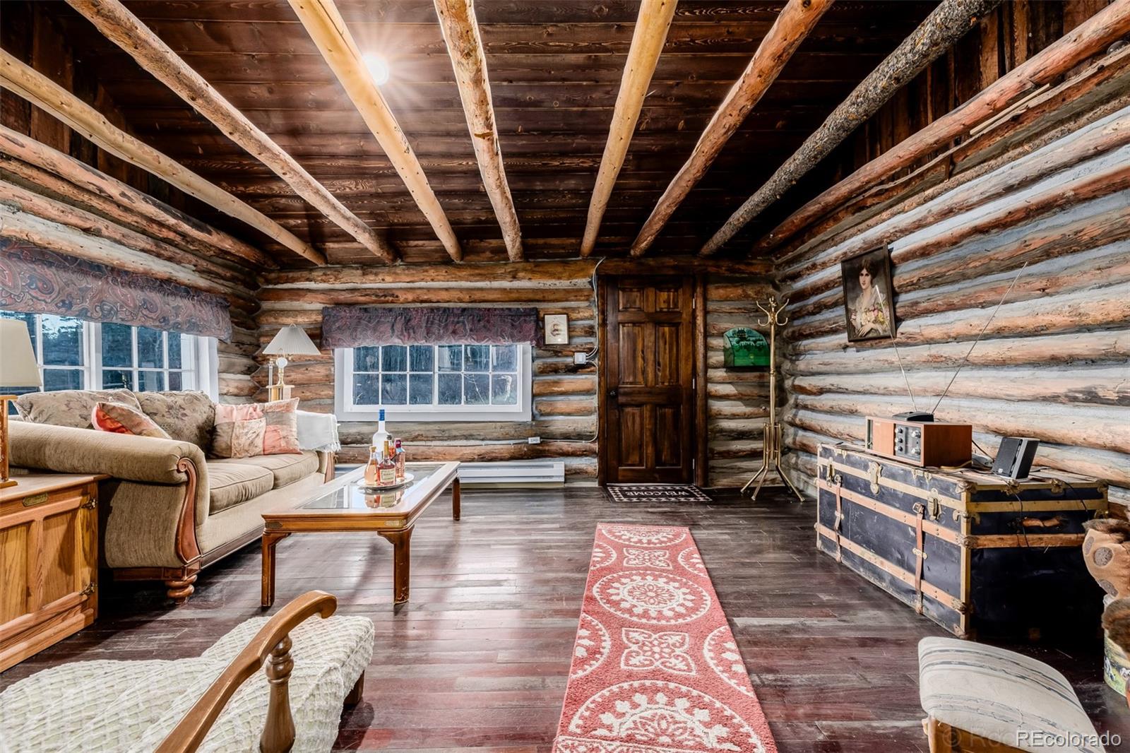 9719 Beaver Pond Conifer, CO 80433 - Photo 9 of 50 a living room with furniture and a wooden floor