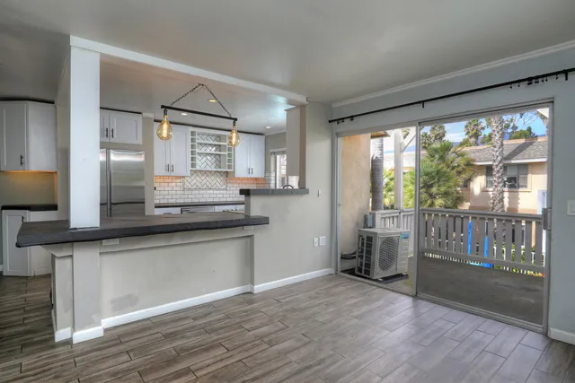 a kitchen with stainless steel appliances granite countertop a sink and wooden floor